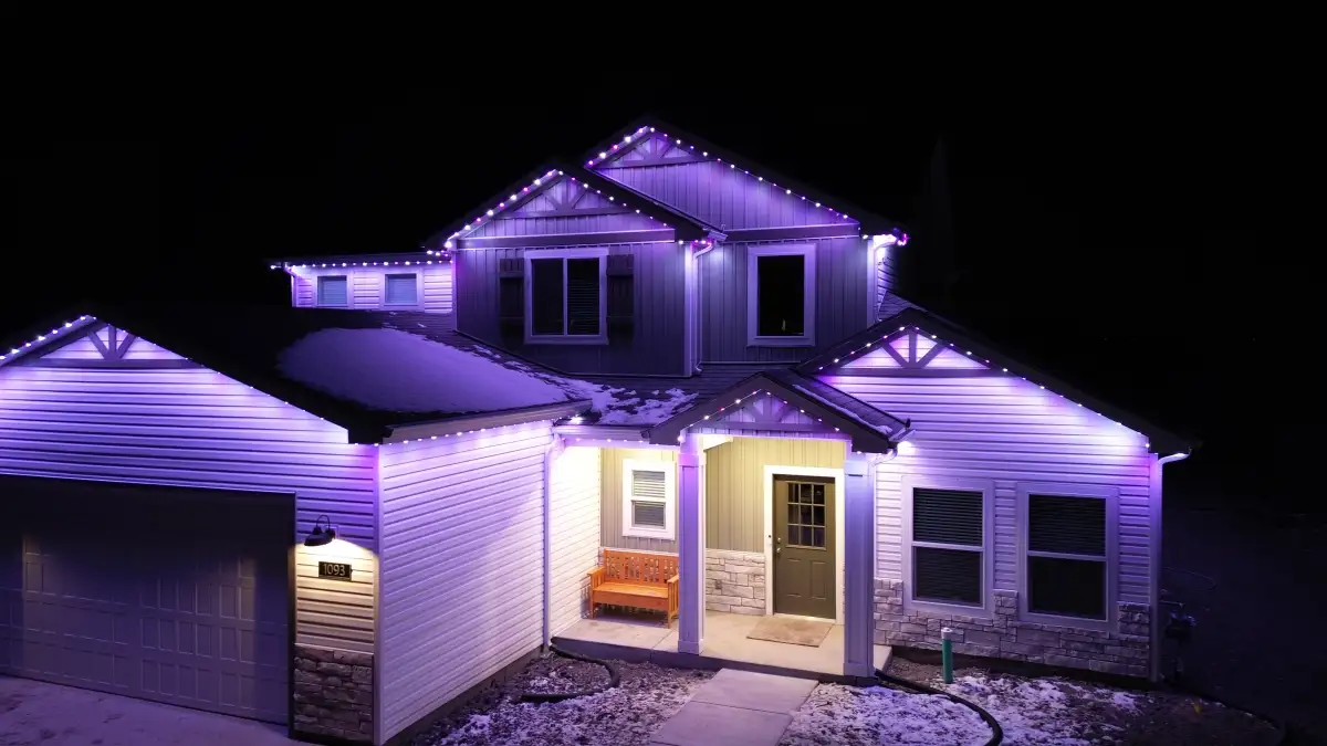 Colorful holiday lighting scene on home roofline